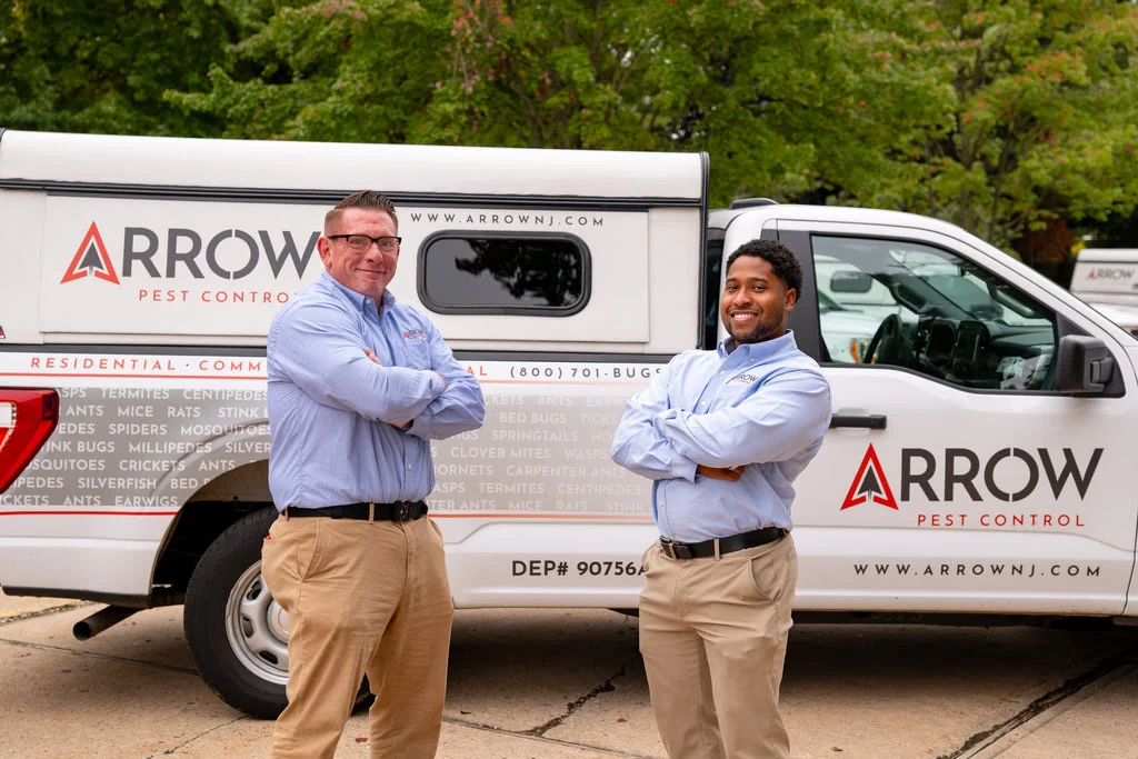 ArrowPestControl person standing in front of truck