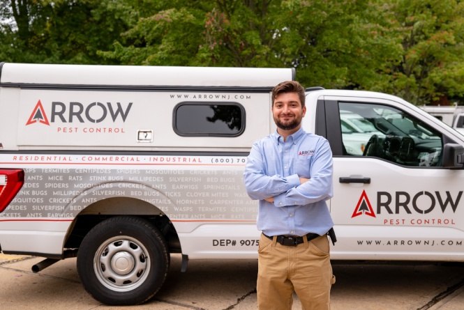 Employee in front of Arrow Pest truck